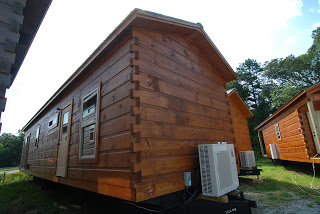 12x44 CABIN IN GUNSTOCK BROWN STAIN PAIRED WITH FOREST GREEN ROOF